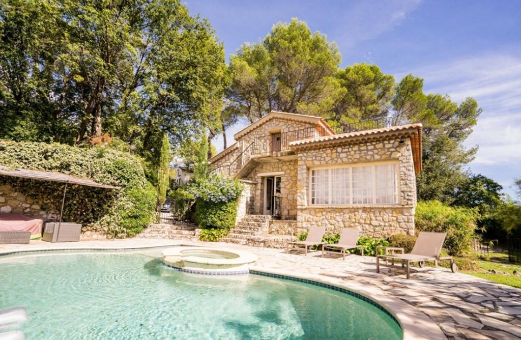 a house with a swimming pool in front of a house at Charming villa - perfectly located in Roquefort-les-Pins