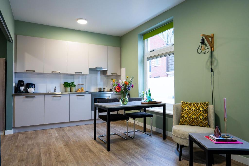 a kitchen with a table and a dining room at Short Stay Wageningen in Wageningen