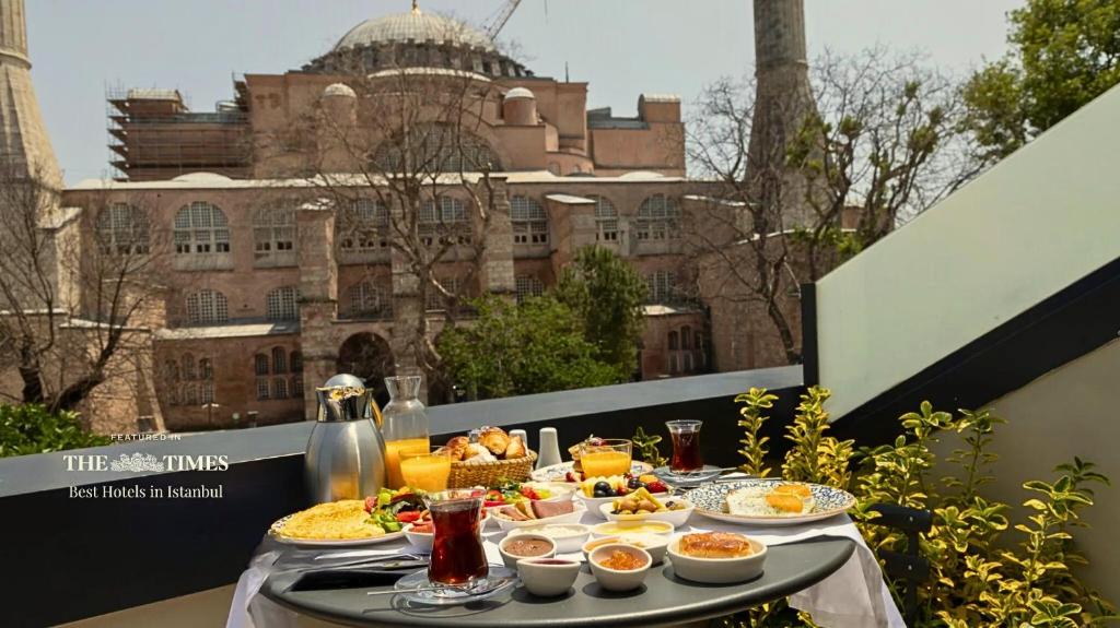 a table with food on a balcony with a building at Hotel Saint Sophia in Istanbul