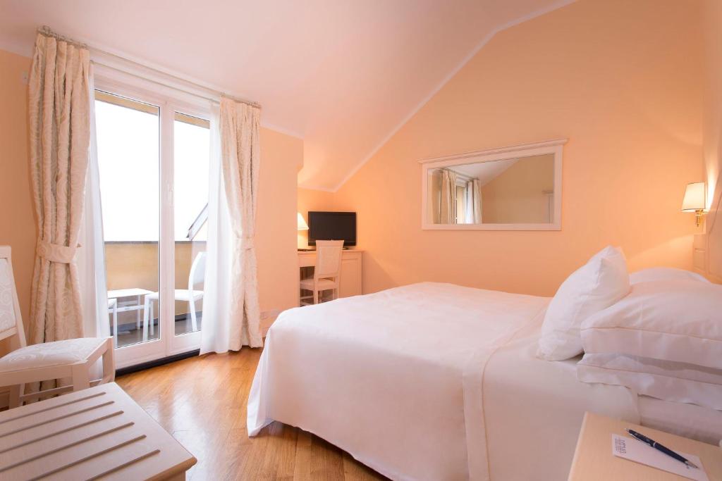 Postel nebo postele na pokoji v ubytování Hotel Cenobio Dei Dogi