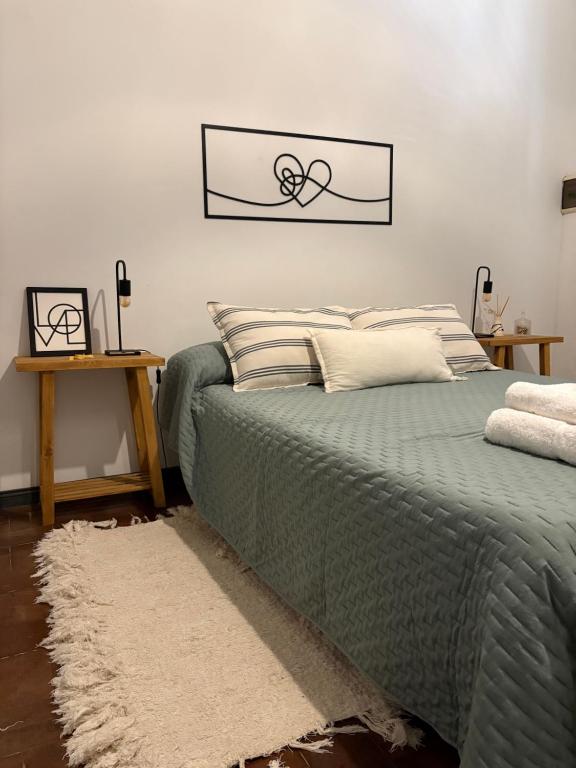 una camera con un letto verde con una foto sul muro di Casa Soul a Chascomús