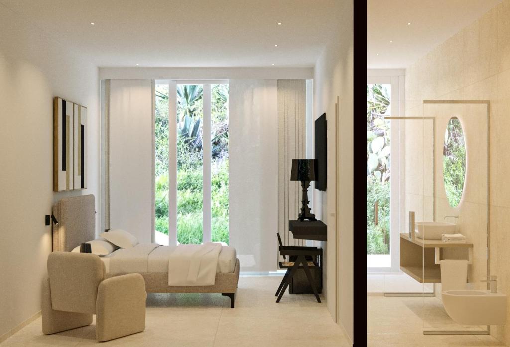 een slaapkamer met een bed en een woonkamer bij Fenici Levanzo Hotel - Adults Only in Levanzo