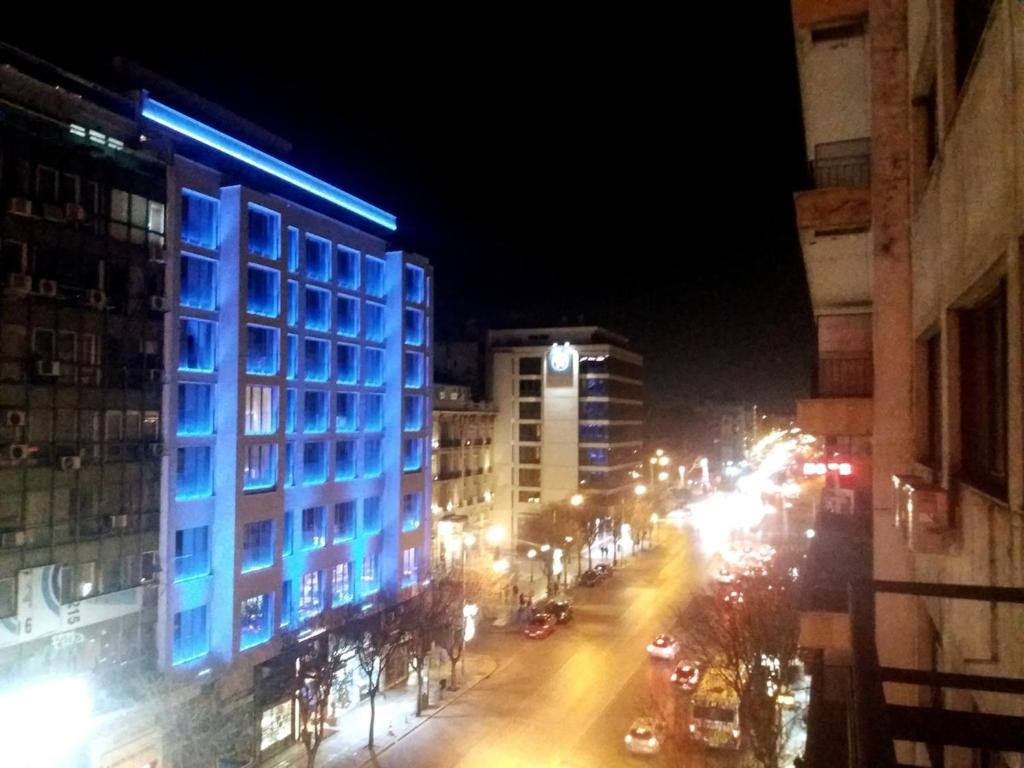 a city street at night with cars and buildings at Restored, immaculate condo @ historic center #1 in Thessaloniki