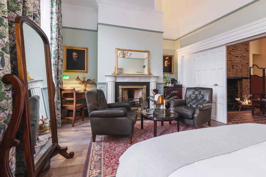 a bedroom with a living room with a fireplace at Ha'penny View House in Dublin