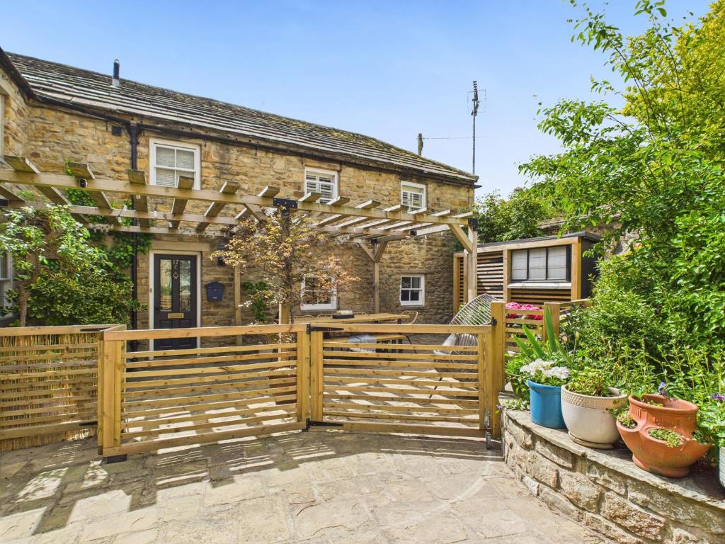 a wooden fence in front of a house at Smithy Stables in Barnard Castle