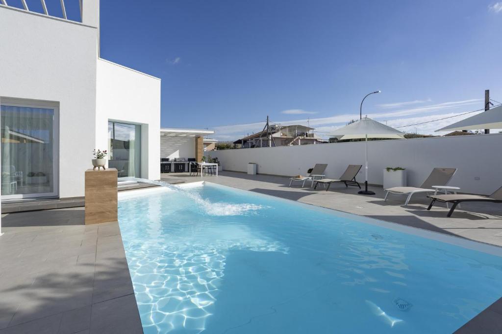 a swimming pool on the roof of a house at Villa Nidea in Ragusa