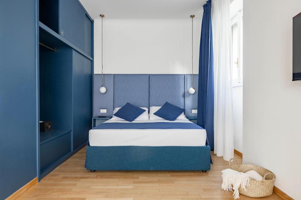 a blue bedroom with a bed with blue walls at Boutique Hotel Maria Vittoria in Rome
