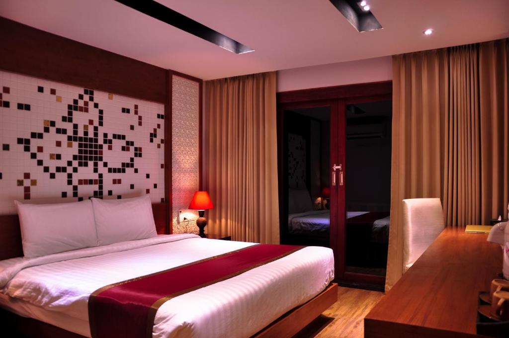 A bed or beds in a room at Phi Phi Natural Resort