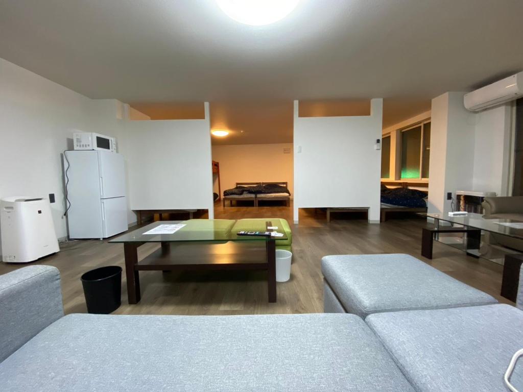 a living room with a couch and a table at ホテル一休 in Otaru