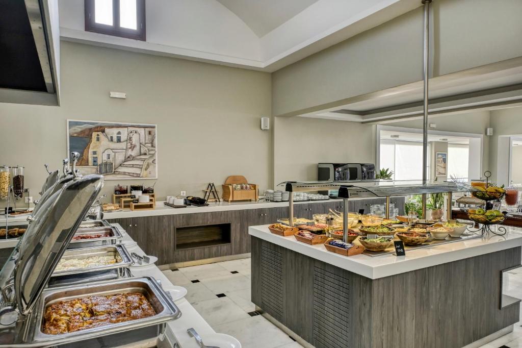 a buffet line with many different types of food at Splendour Hotel and Suites in Firostefani