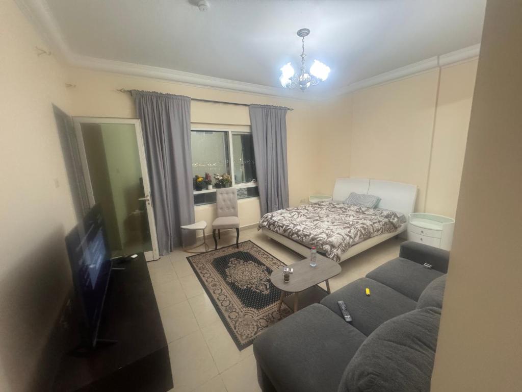 a living room with a couch and a bed at Sryia 1 in Sharjah