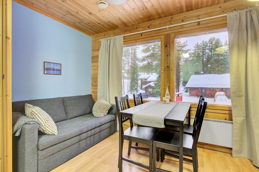 a living room with a couch and a table at Pyhäkoti B - 30 Meters From the Slopes in Pyhätunturi