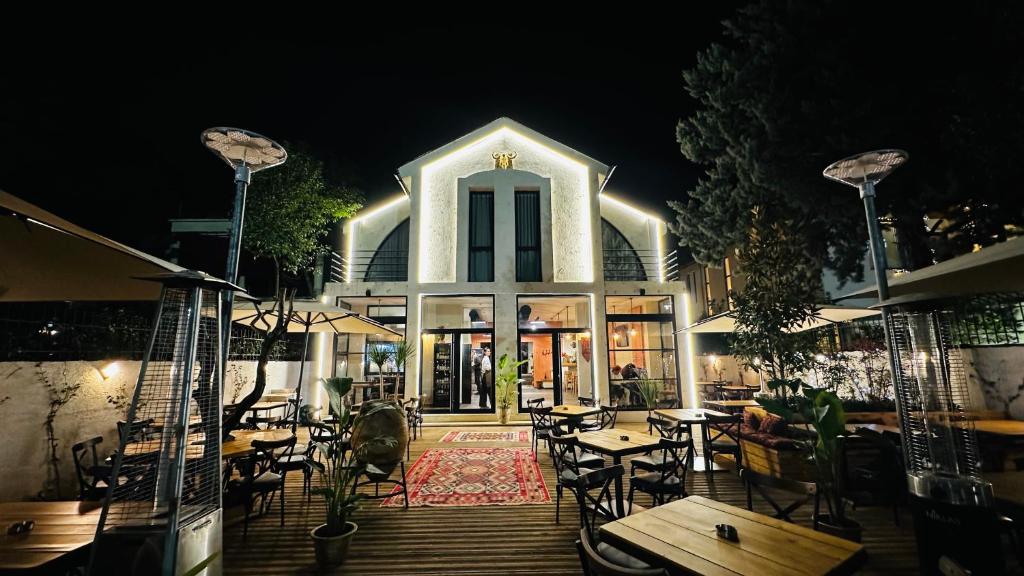 a restaurant with tables and chairs in front of a building at Villa Garden Boutique Hotel Tirana in Tirana