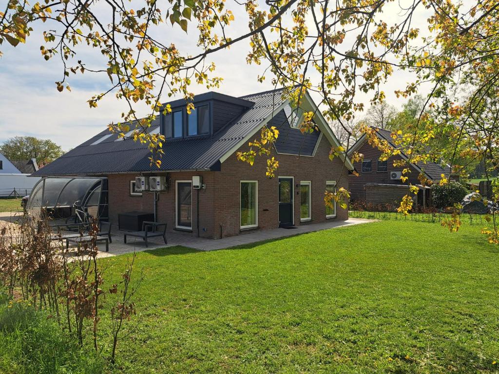 洛赫姆Erve Lindehof的一座黑屋顶和庭院的房子