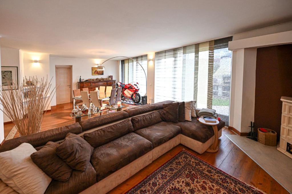 a living room with a large brown leather couch at Host Monti del Sole in Meano