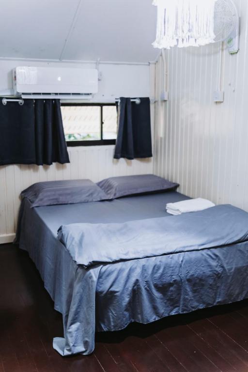 a bedroom with two beds and a window at Dedaun Homestay in Tamparuli