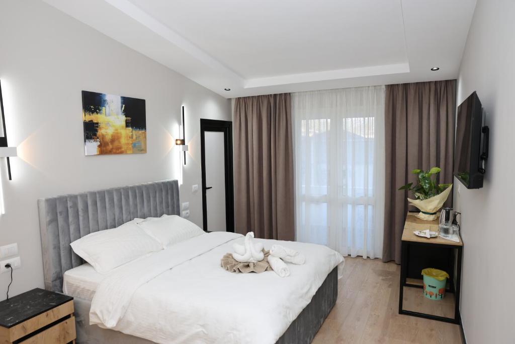 Postel nebo postele na pokoji v ubytování Kremelo Hotel