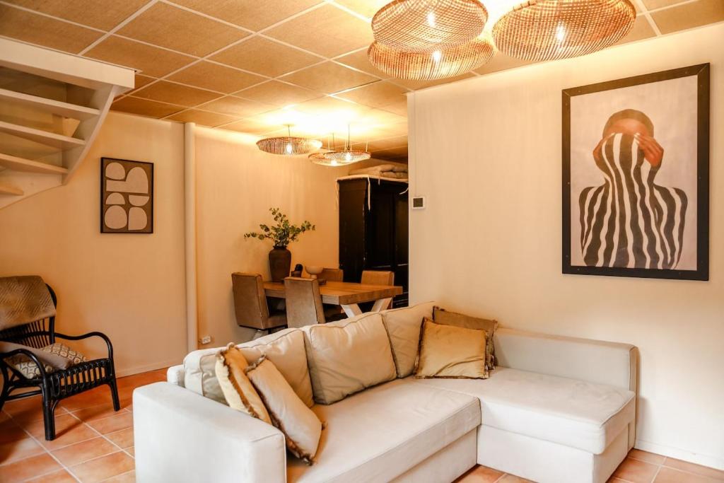 a living room with a white couch and a table at Cityloft centrum Breda met privé tuin VP092 in Breda