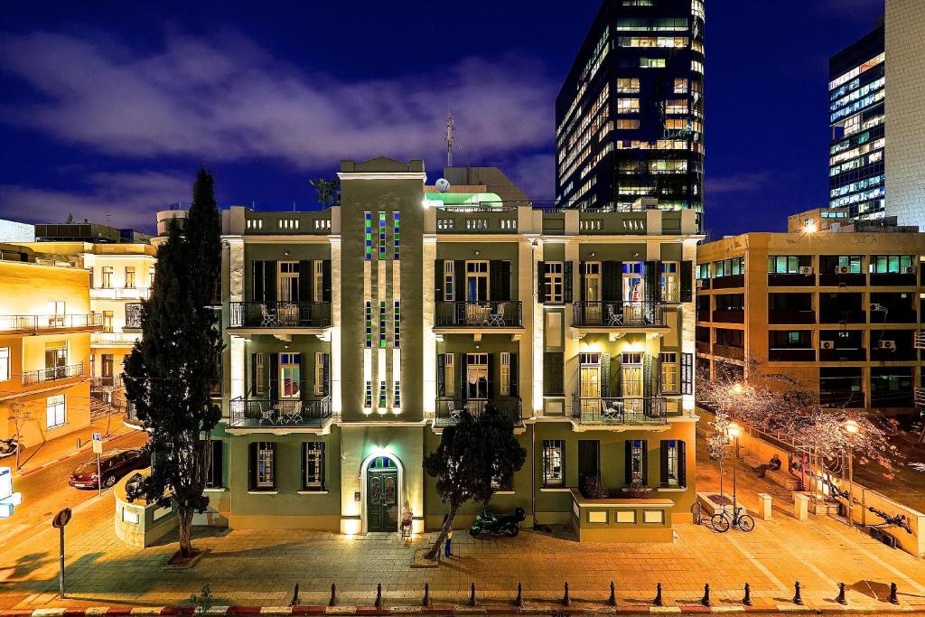 a large building in a city at night at Alma Boutique Hotel & Lounge in Tel Aviv
