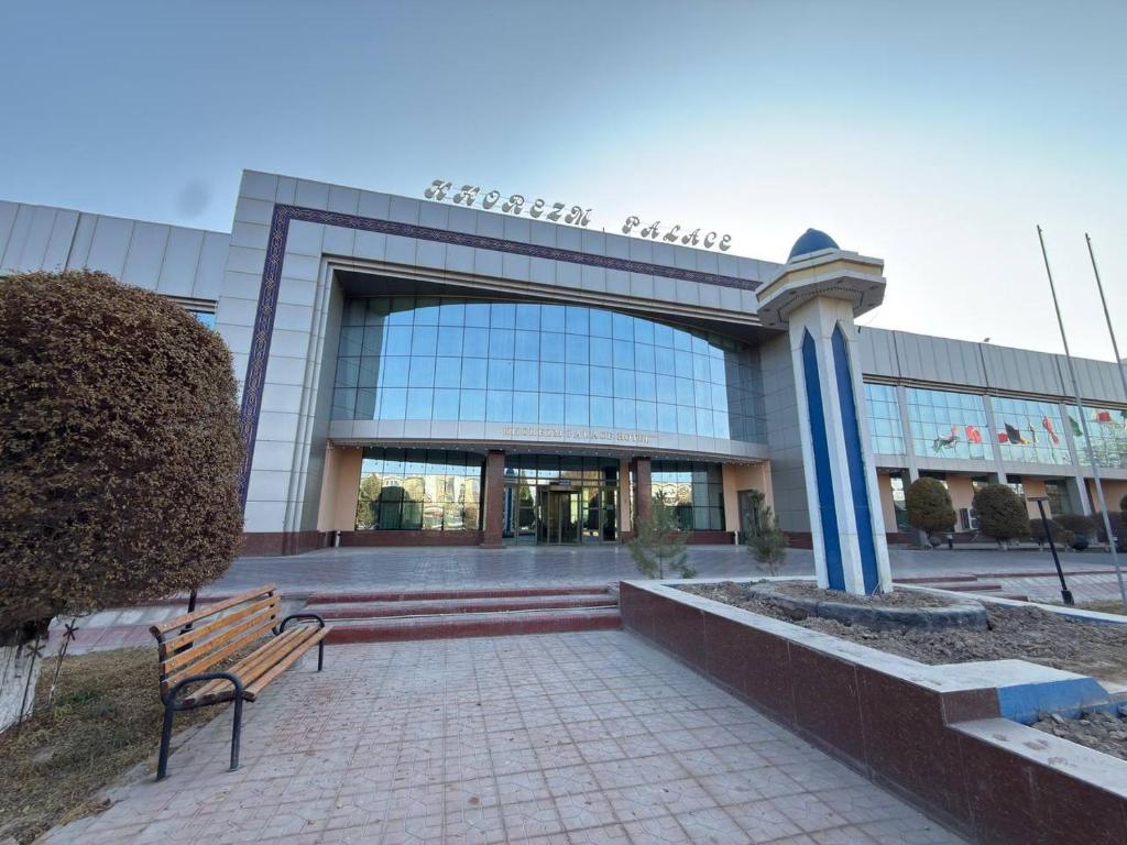 乌尔根奇Khorezm Palace Hotel的前面有长凳的建筑