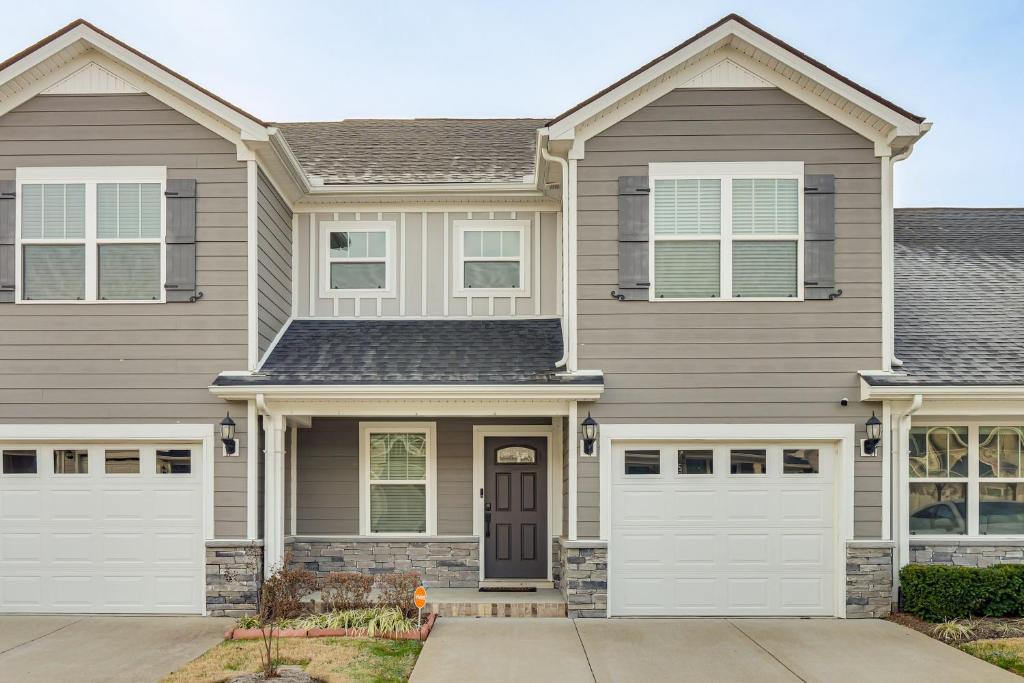 een huis met witte garagedeuren bij WFH Setup, Fenced Yard! Spacious Spring Hill Stay in Kedron