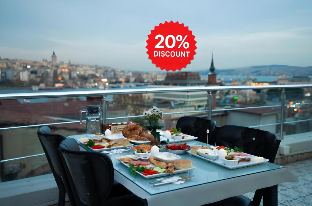 a table with plates of food on top of a balcony at Golden Horn Park Hotel in Istanbul