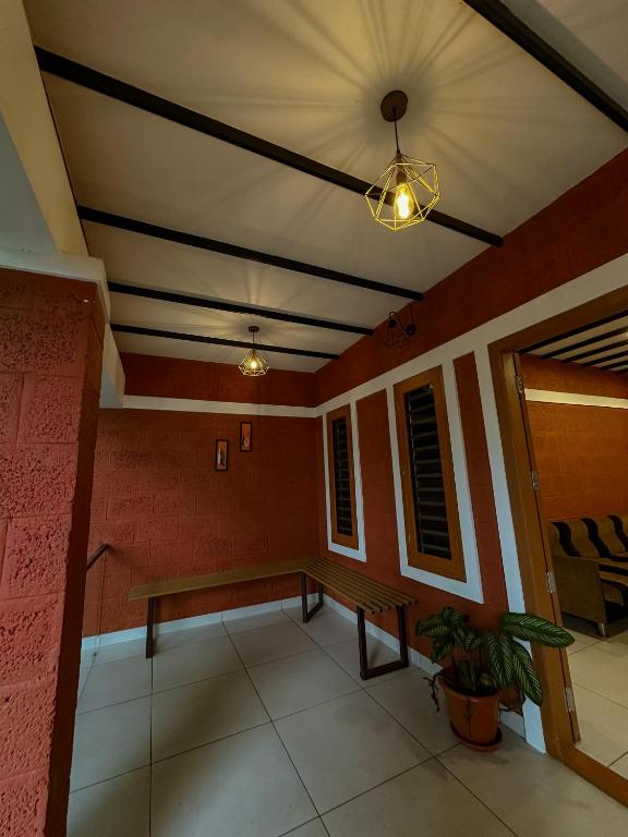 a room with a bench and a ceiling at Rockviewstay in Kalpetta