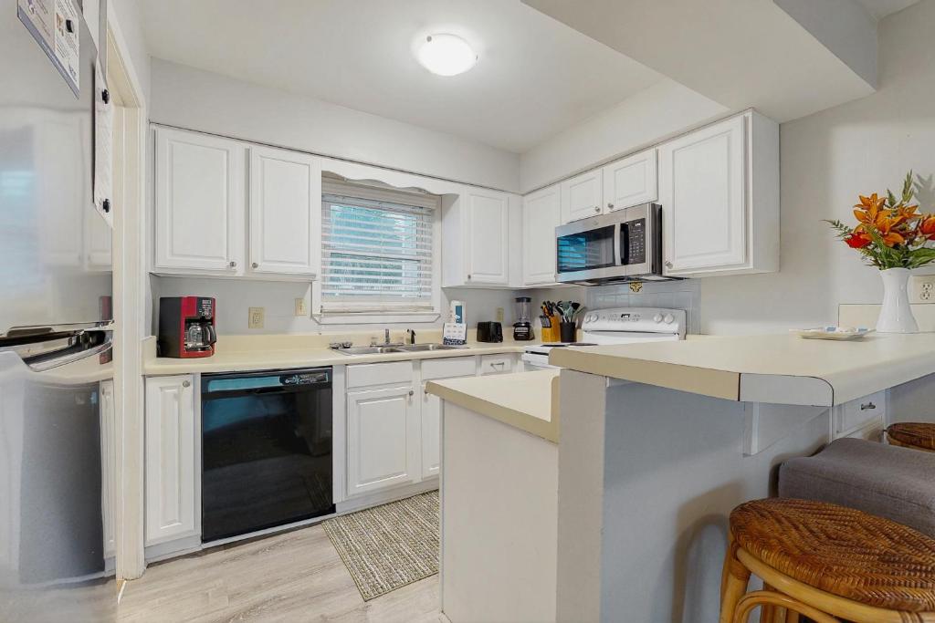 a kitchen with white cabinets and a counter top at Fort Morgan Townhomes E7 in Fort Morgan