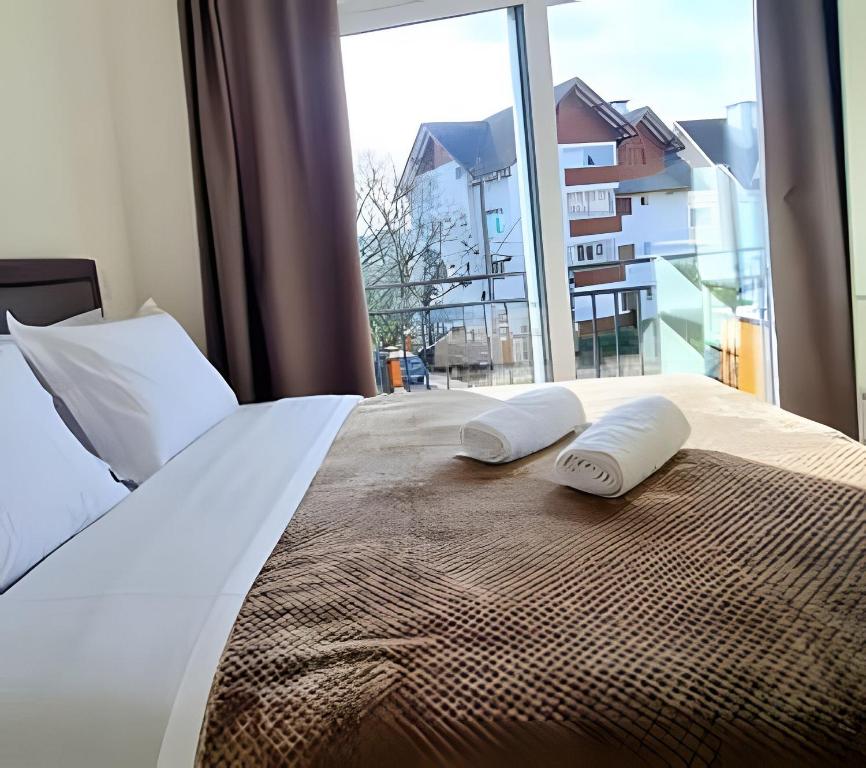 a bedroom with a bed with two pillows on it at Apartamento Loft Gramado in Gramado