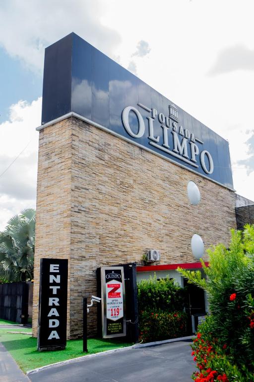 a building with a sign on the side of it at Pousada Olimpo in Ananindeua
