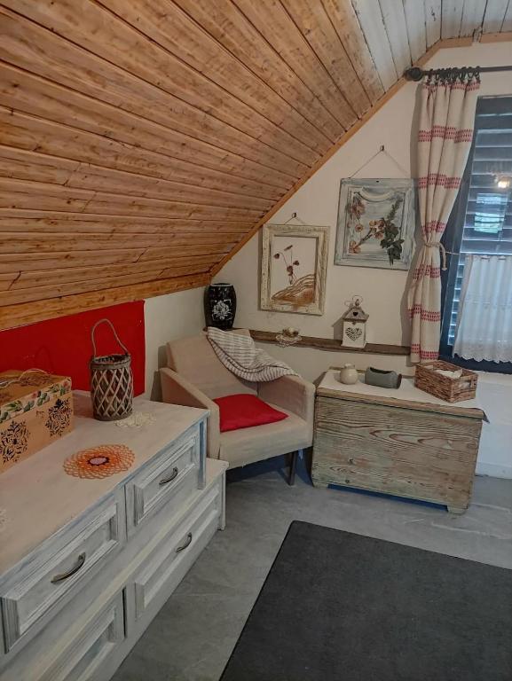 a room with a bed and a couch and a table at Menyecske Guesthouse in Keszü