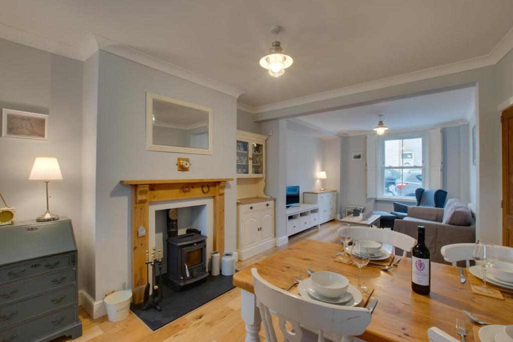 a living room with a table and a fireplace at 2 Bed in Mumbles oc-hh1201 in The Mumbles