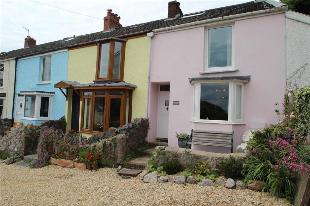 a group of houses in a yard with flowers at 2 Bed in Mumbles oc-hh133 in The Mumbles