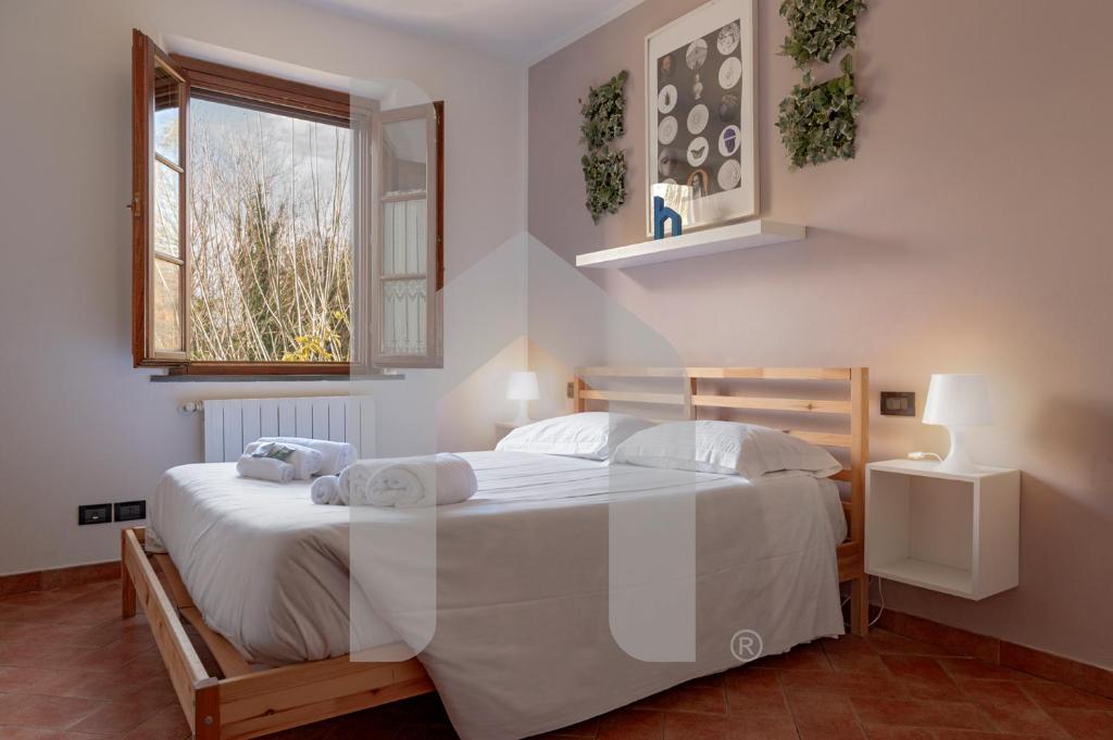 Postel nebo postele na pokoji v ubytování Homiday - Tuscany House - Parcheggio e Giardino Privato