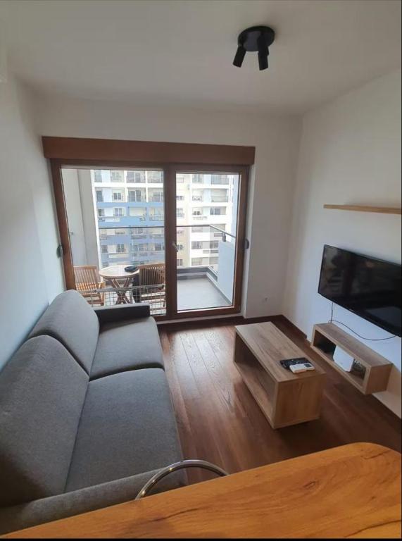 a living room with a couch and a table at Master Quart studio apartment in Podgorica