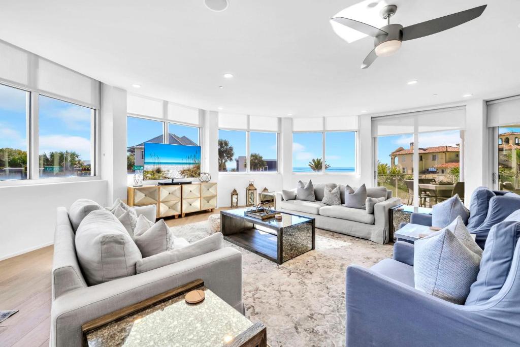 a living room with two couches and a ceiling fan at Viridian 201 in Santa Rosa Beach