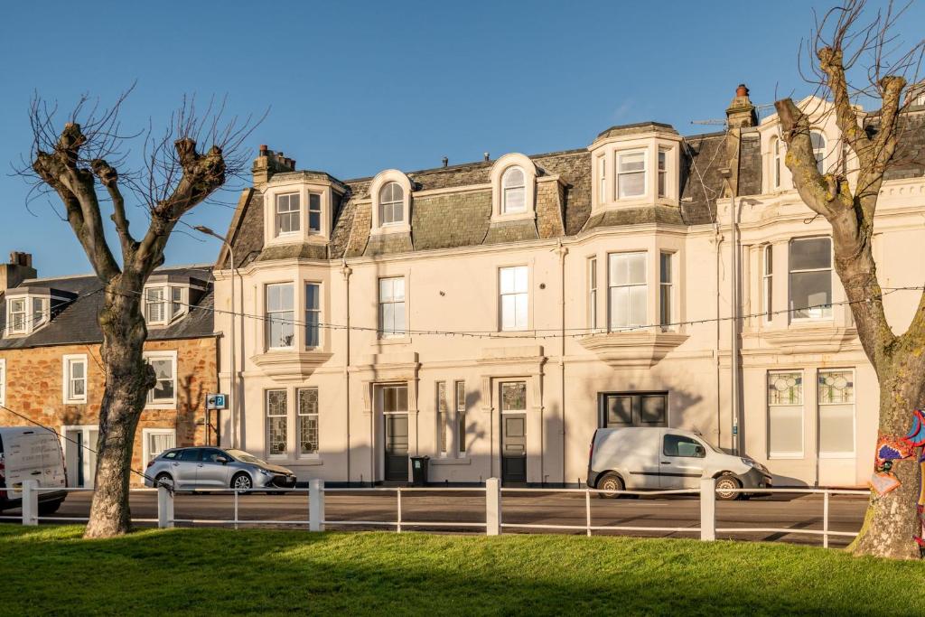 a large building with cars parked in front of it at The Crow's Nest - Elie in Elie