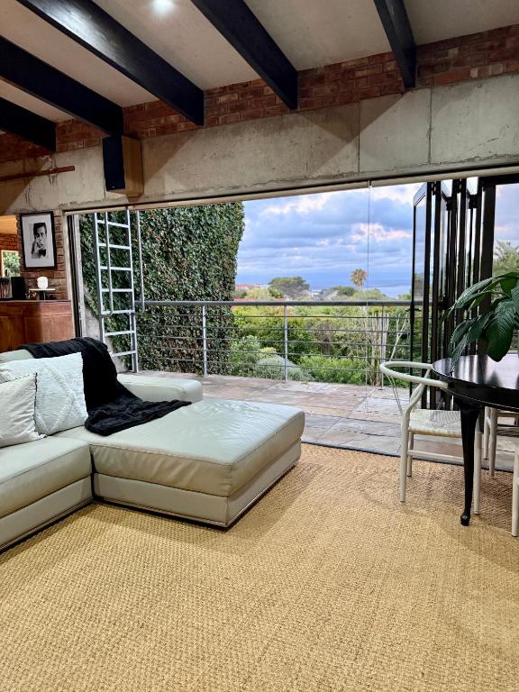 a living room with a couch and a table at 007 Loft in Mossel Bay