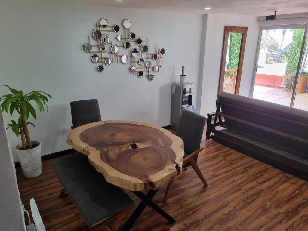 a dining room with a wooden table and chairs at La mejor ubicación Condomar 133 in Puerto Vallarta