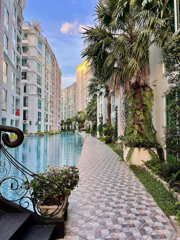 a street with a pool of water between buildings at City Garden Olympus condo balcony in Pattaya South
