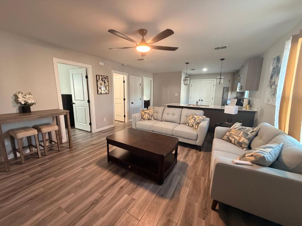 a living room with a couch and a table at Executive Comfort Suite in Weslaco
