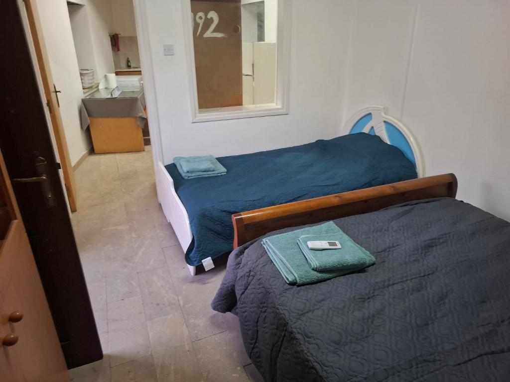 a bedroom with two beds and a bathroom with a sink at Simou Apartment in Simou