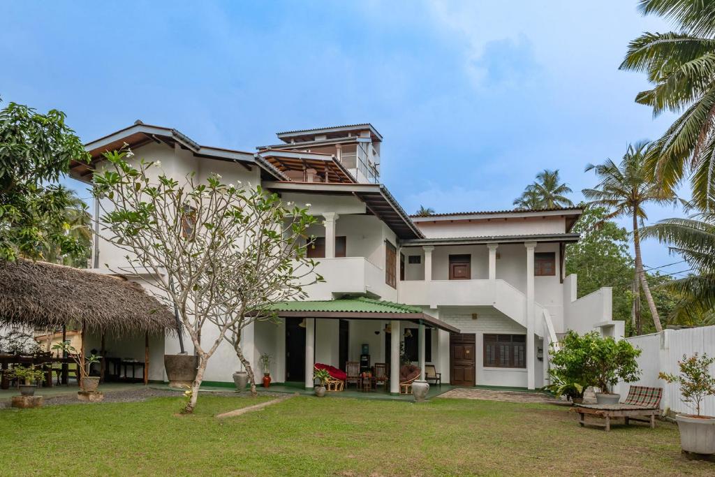 an exterior view of a house with a yard at Ayana wellness resort in Talpe