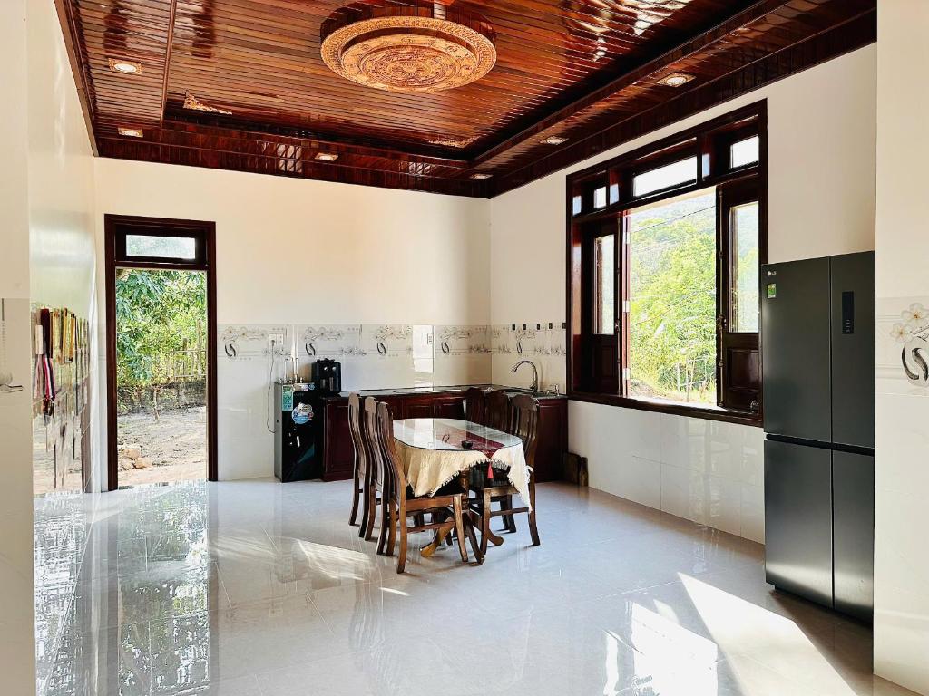 a kitchen with a table and chairs in a room at Nutty Village Phu Quoc in Phú Quốc