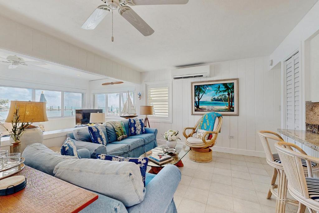 een woonkamer met blauwe banken en een tafel bij Casa Del Mar in Key Colony Beach