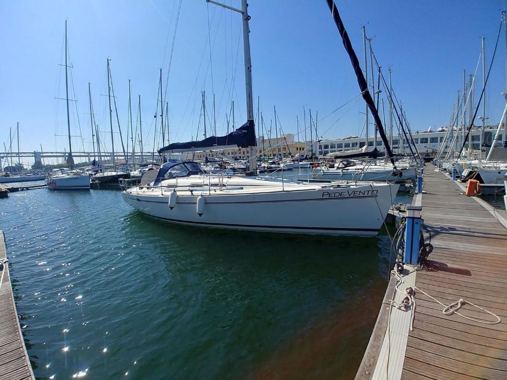 een boot is aangemeerd op een dok in het water bij Sleep on a Sailboat in Lisbon a unique stay in Lissabon