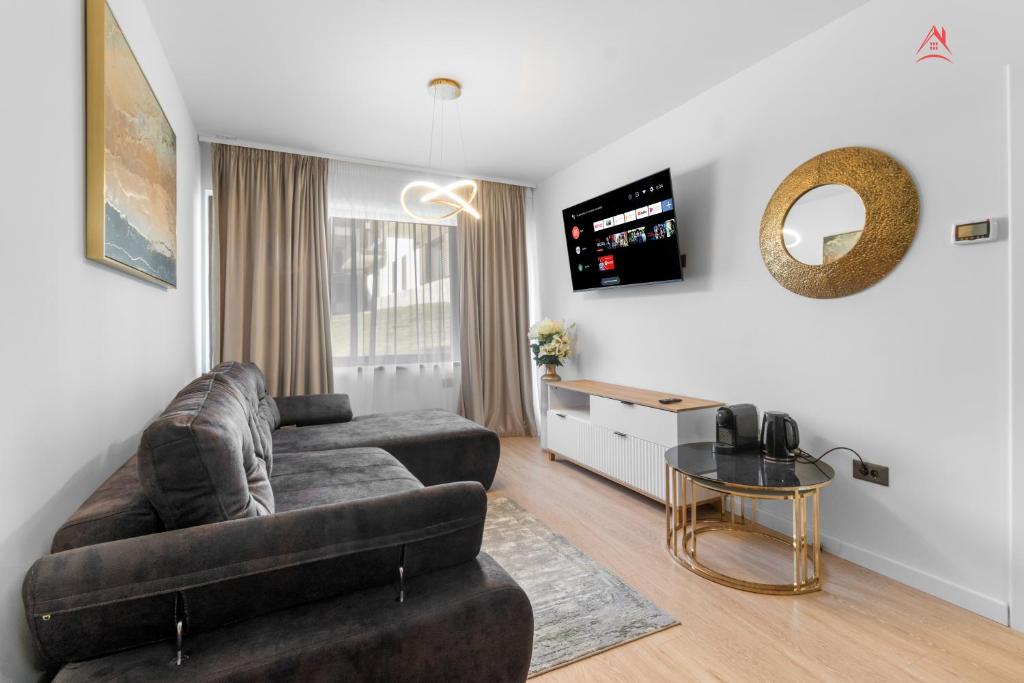 a living room with a couch and a table at Apartament 1 C4 Grand Chalet Poiana Brasov in Braşov