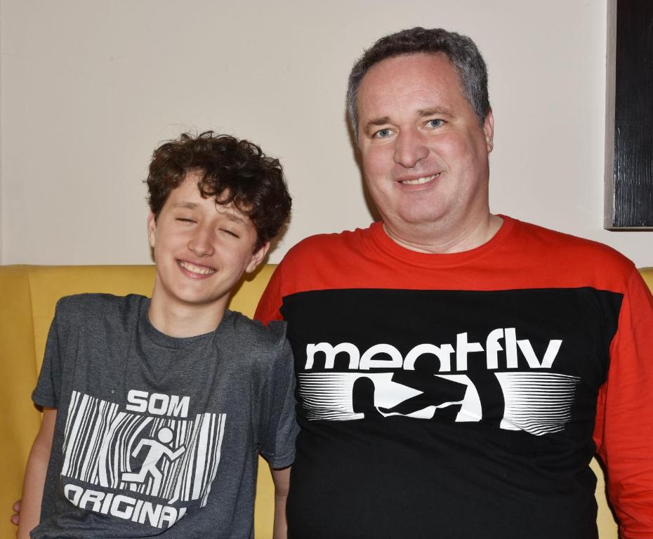 Twee mannen staan naast elkaar, beiden in T-shirts. bij Penzion Brzotín in Brzotín