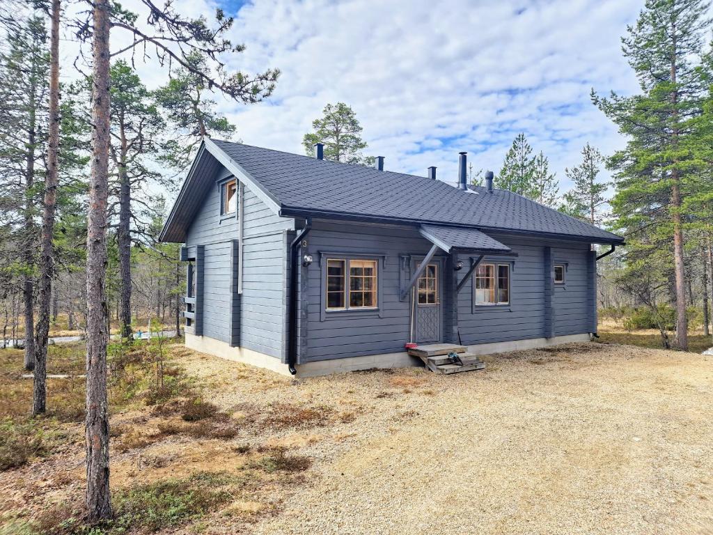 a blue tiny house in the woods at Pääsiäiskuru 3 in Kakslauttanen