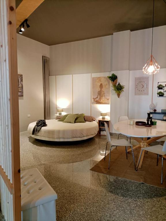 a bedroom with a bed and a table and chairs at Cerchio di Luce in Locorotondo
